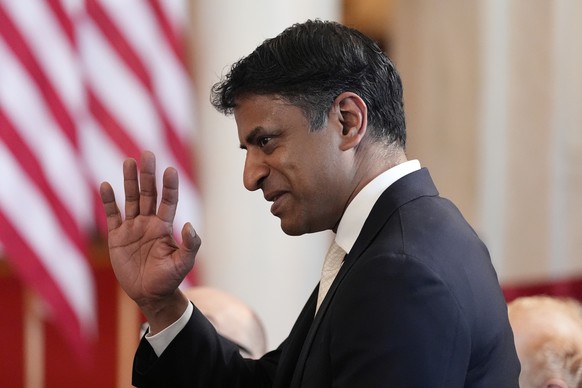 Novartis CEO Vasant Narasimhan stands as President Donald Trump speaks about investing in America in the Cross Hall of the White House, Wednesday, April 30, 2025, in Washington. (AP Photo/Alex Brandon ...