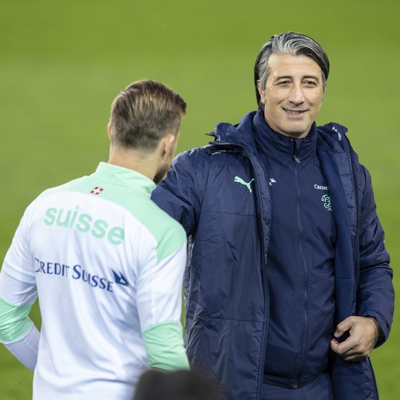 Switzerland&#039;s head coach Murat Yakin, right, speaks with Silvan Widmer during a training session the day before the 2022 FIFA World Cup European Qualifying Group C soccer match between Switzerlan ...