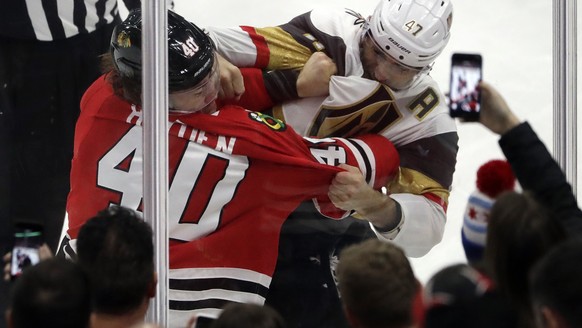 Chicago Blackhawks right wing John Hayden, left, and Vegas Golden Knights defenseman Luca Sbisa fight during the second period of an NHL hockey game Friday, Jan. 5, 2018, in Chicago. (AP Photo/Nam Y.  ...