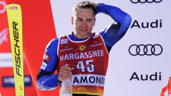 Greece&#039;s Aj Ginnis celebrates on the podium after taking second place in an alpine ski, men&#039;s World Cup slalom in Chamonix, France, Saturday, Feb. 4, 2023. (AP Photo/Pier Marco Tacca)