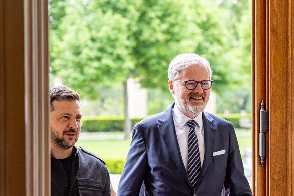 epa12074584 Czech Prime Minister Petr Fiala (R) welcomes Ukrainian President Volodymyr Zelensky (L) prior to their meeting in Prague, Czech Republic, 05 May 2025. The Ukrainian head of state is on a t ...