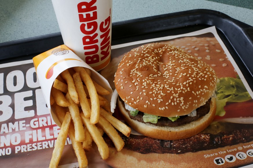 FILE- This Feb. 1, 2018, file photo shows a Burger King Whopper meal combo at a restaurant in Punxsutawney, Pa. Restaurant Brands International, the parent company of Burger King and Tim Hortons, repo ...