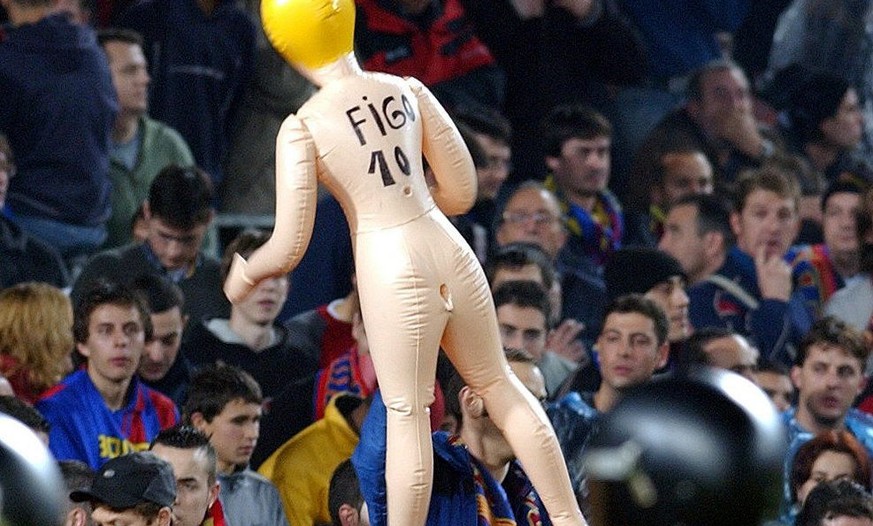 Real Madrid&#039;s Portugues player Luis Figo is protected by police as he takes a corner during a Spanish league soccer match against his old club Barcelona in Barcelona Saturday Nov 23, 2002. Figo w ...