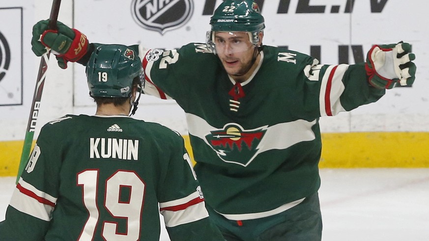 Minnesota Wild&#039;s Nino Niederreiter, right, of Switzerland, celebrates Luke Kunin&#039;s goal off Winnipeg Jets goalie Connor Hellebuyck during the third period of an NHL hockey game Tuesday, Oct. ...