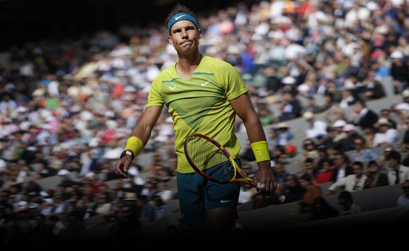 Spain's Rafael Nadal walks back to the baseline to serve against Canada's Felix Auger-Aliassime during their fourth round match at the French Open tennis tournament in Roland Garros stadium in Paris, France, Sunday, May 29, 2022. (AP Photo/Christophe Ena)