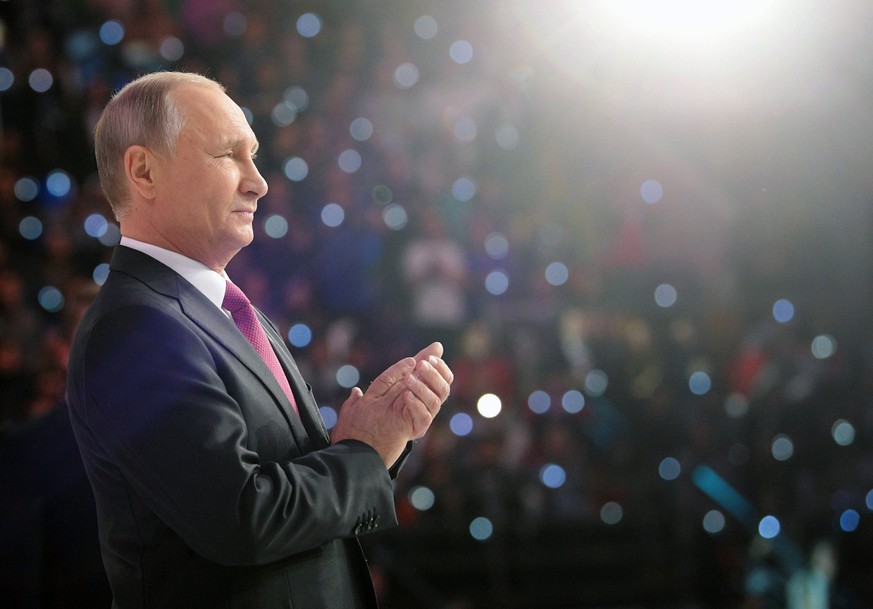 epa06371294 Russian president Vladimir Putin greets participants as he appears to take part in the forum of Russian volunteers in Moscow, 06 December 2017. Vladimir Putin announced his plans to take h ...