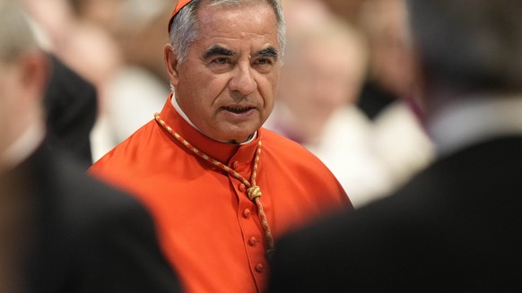 FILE - Cardinal Angelo Becciu attends the consistory inside St. Peter&#039;s Basilica at the Vatican, on Aug. 27, 2022. Lawyers for a once-powerful cardinal accused Vatican prosecutors of being ?priso ...