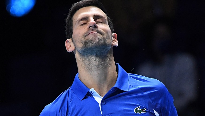 epa08833618 Novak Djokovic of Serbia in action against Dominic Thiem of Austria during their semi final match at the ATP World Tour Finals tennis tournament in London, Britain, 21 November 2020. EPA/A ...