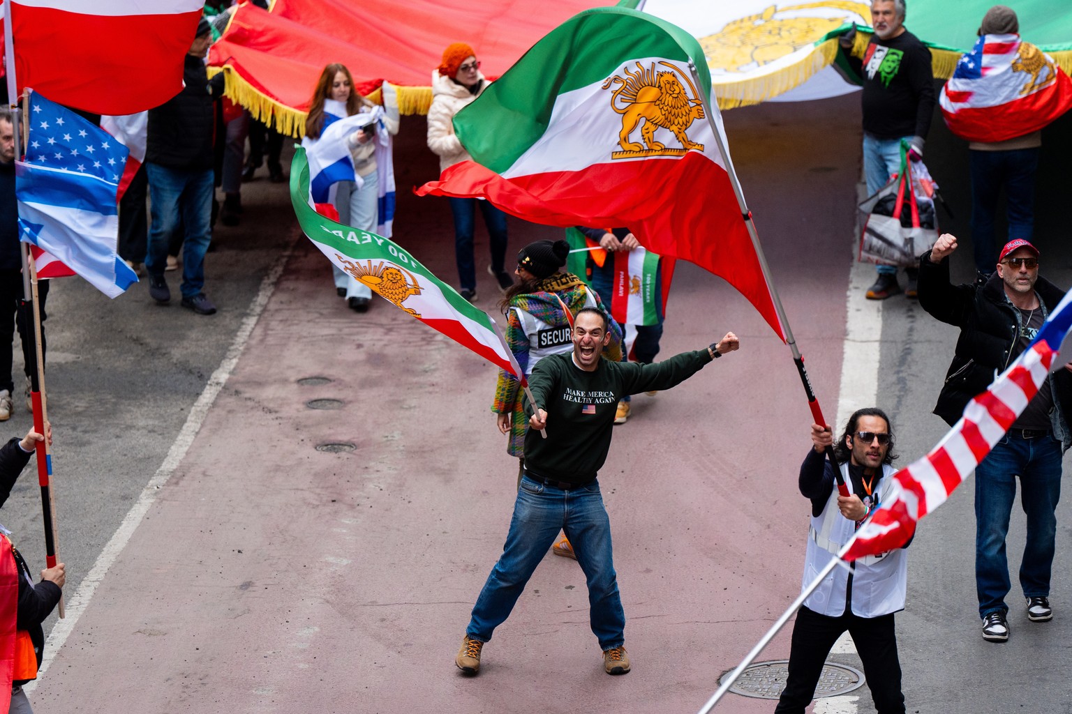Nami Poursohi waves an Iranian flag as people march toward Times Square during an anti-Iranian regime demonstration hosted by Lion Sun NY in support of Donald Trump and Israel's actions against t ...