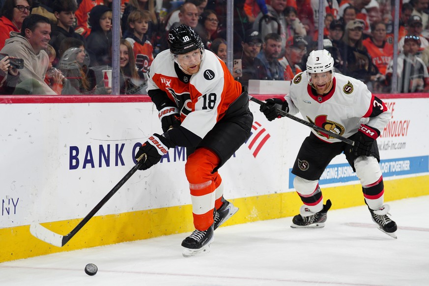 Philadelphia Flyers' Rodrigo Abols, left, plays the puck ahead of Ottawa Senators' Nick Jensen during the second period of an NHL hockey game, Saturday, Nov. 8, 2025, in Philadelphia. (AP Ph ...