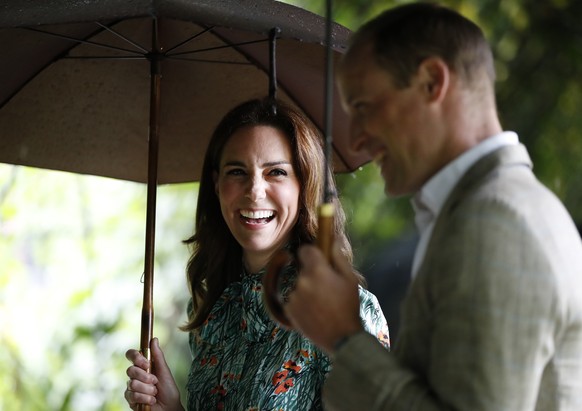 Britain&#039;s Prince William and his wife Kate, Duchess of Cambridge smile as they walk through the memorial garden in Kensington Palace, London, Wednesday, Aug. 30, 2017. Princes William and Harry a ...