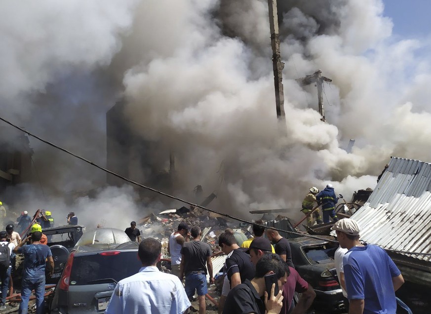 Smoke rises from Surmalu market about two kilometers (1.2 miles) south of the center Yerevan, Armenia, Sunday, Aug. 14, 2022. A strong explosion hit a large market in the capital of Armenia on Sunday, ...