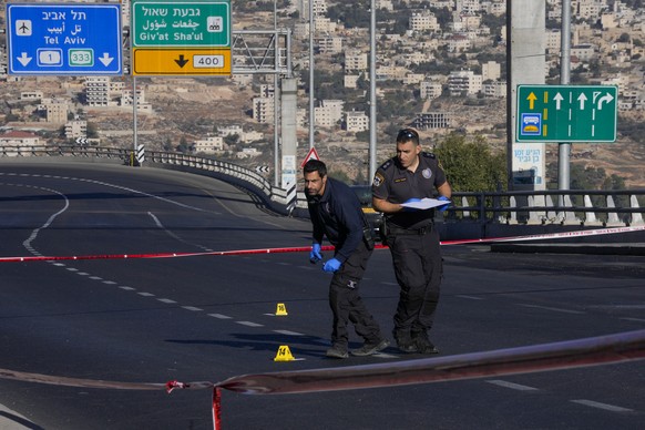 Israeli police inspect the scene of an explosion at a bus stop in Jerusalem, Wednesday, Nov. 23, 2022. Two blasts went off near bus stops in Jerusalem on Wednesday, injuring several people in what pol ...