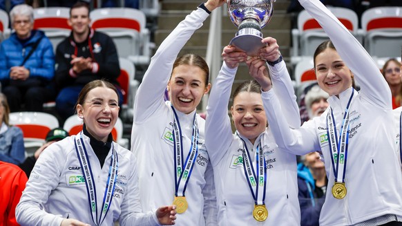 From left to right, Switzerland skip Xenia Schwaller, third Selina Gafner, vice-skip Fabienne Rieder and lead Selina Rychiger raise the trophy after defeating Canada to win the World Women's Curl ...