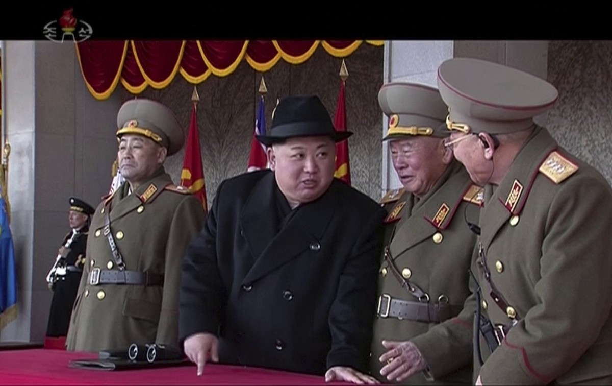 In this image made from video by North Korea's KRT, North Korean leader Kim Jong Un, center, speaks with military officials during a military parade in Pyongyang, North Korea Thursday, Feb. 8, 20 ...