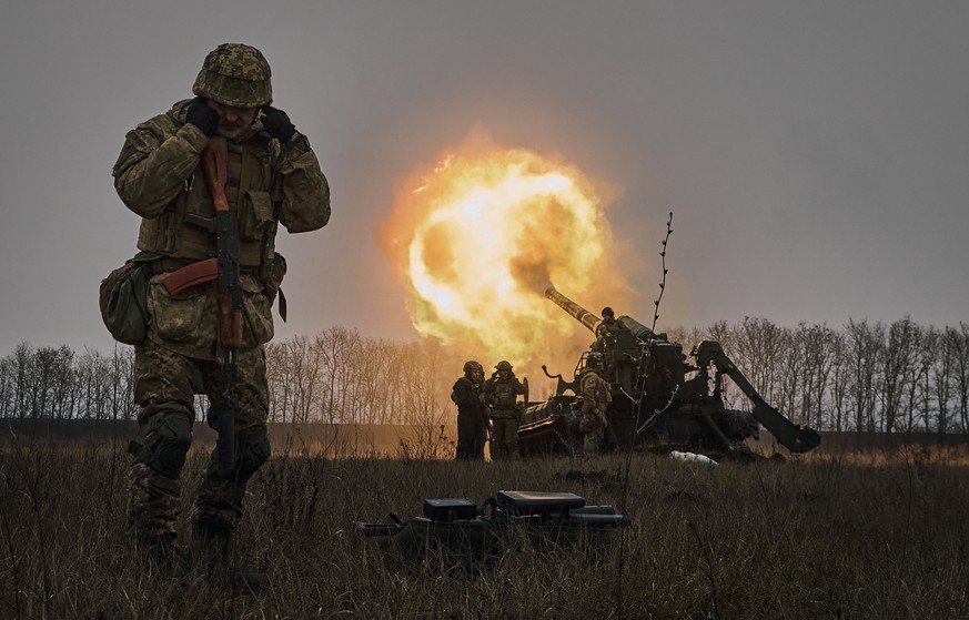 FILE - Ukrainian soldiers fire a Pion artillery system at Russian positions near Bakhmut, Donetsk region, Ukraine, Friday, Dec. 16, 2022. (AP Photo/LIBKOS, File)