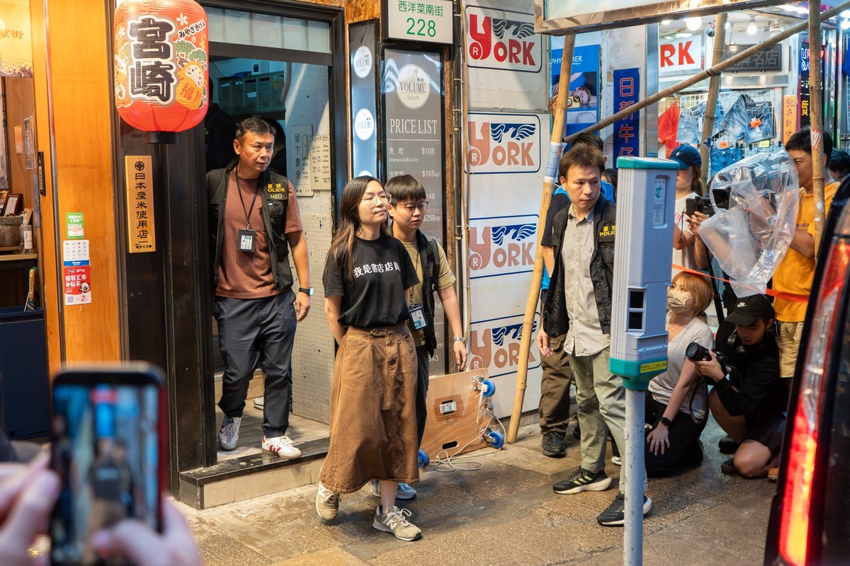 July 15, 2026, Hong Kong, China: An independent bookstore employee is escorted away from Have a Nice Stay independent bookstore by Hong Kong national security police. Hong Kongs national security poli ...
