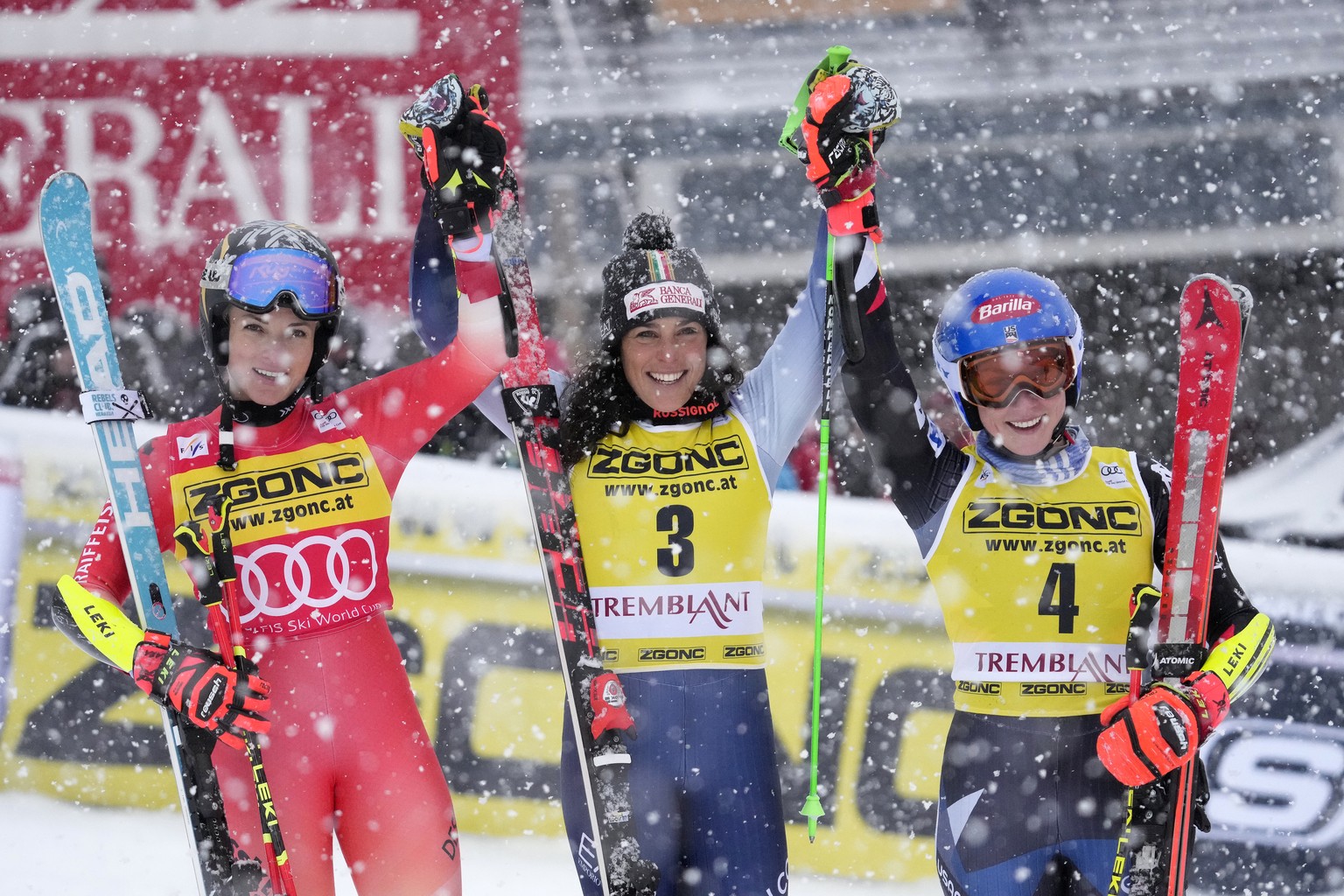 First place finisher Federica Brignone of Italy (3) raises hands together with second place Lara Gut-Behrami of Switzerland and third place Mikaela Shiffrin of the USA (4) at the end of the women&#039 ...