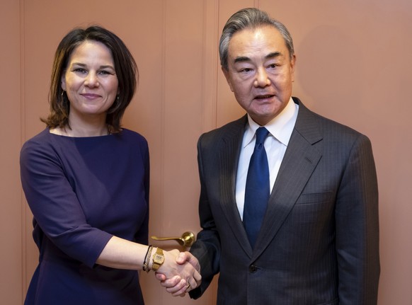 German Foreign Minister Annalena Baerbock, left, shakes hands with China&#039;s Director of the Office of the Central Foreign Affairs Commission Wang Yi for a bilateral meeting at the Munich Security  ...