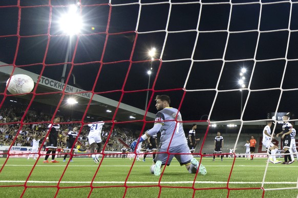 Lugano&#039;s goalkeeper Amir Saipi looks at the ball after Fenerbahce&#039;s Edin Dzeko scored his side&#039;s second goal during a UEFA Champions League qualifying second round first leg soccer matc ...