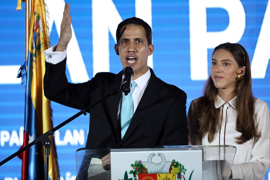 epa07334201 Head of Parliament Juan Guaido (C) presents the Country Plan his wife Fabiana Rosales (R), at the Orange Auditorium of the Faculty of Economic and Social Sciences (FaCES) of the Central Un ...