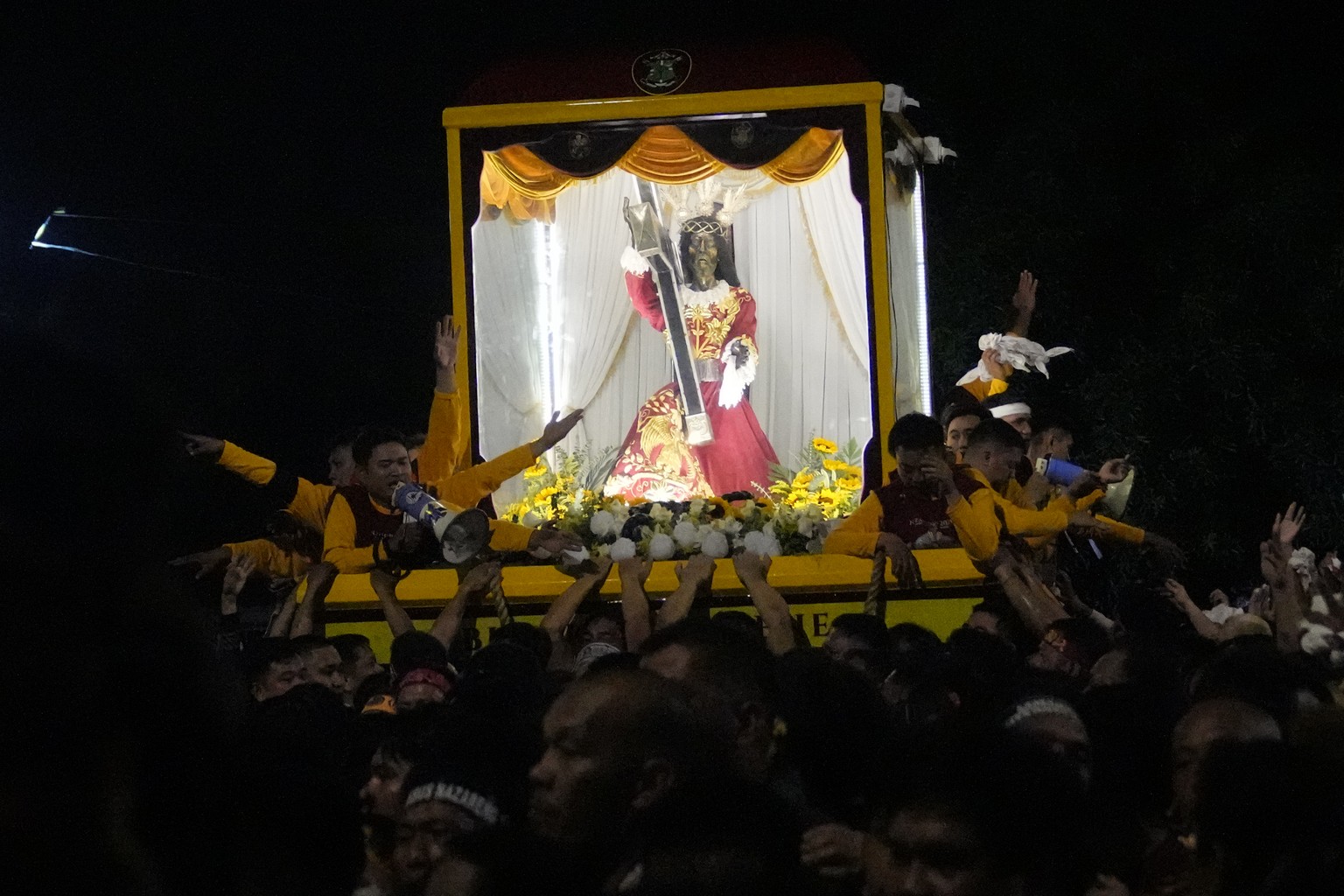 Devotees pull the statue of the Black Nazarene during its annual procession which was resumed after a three-year suspension due to the coronavirus pandemic on Tuesday, Jan. 9, 2024 in Manila, Philippi ...