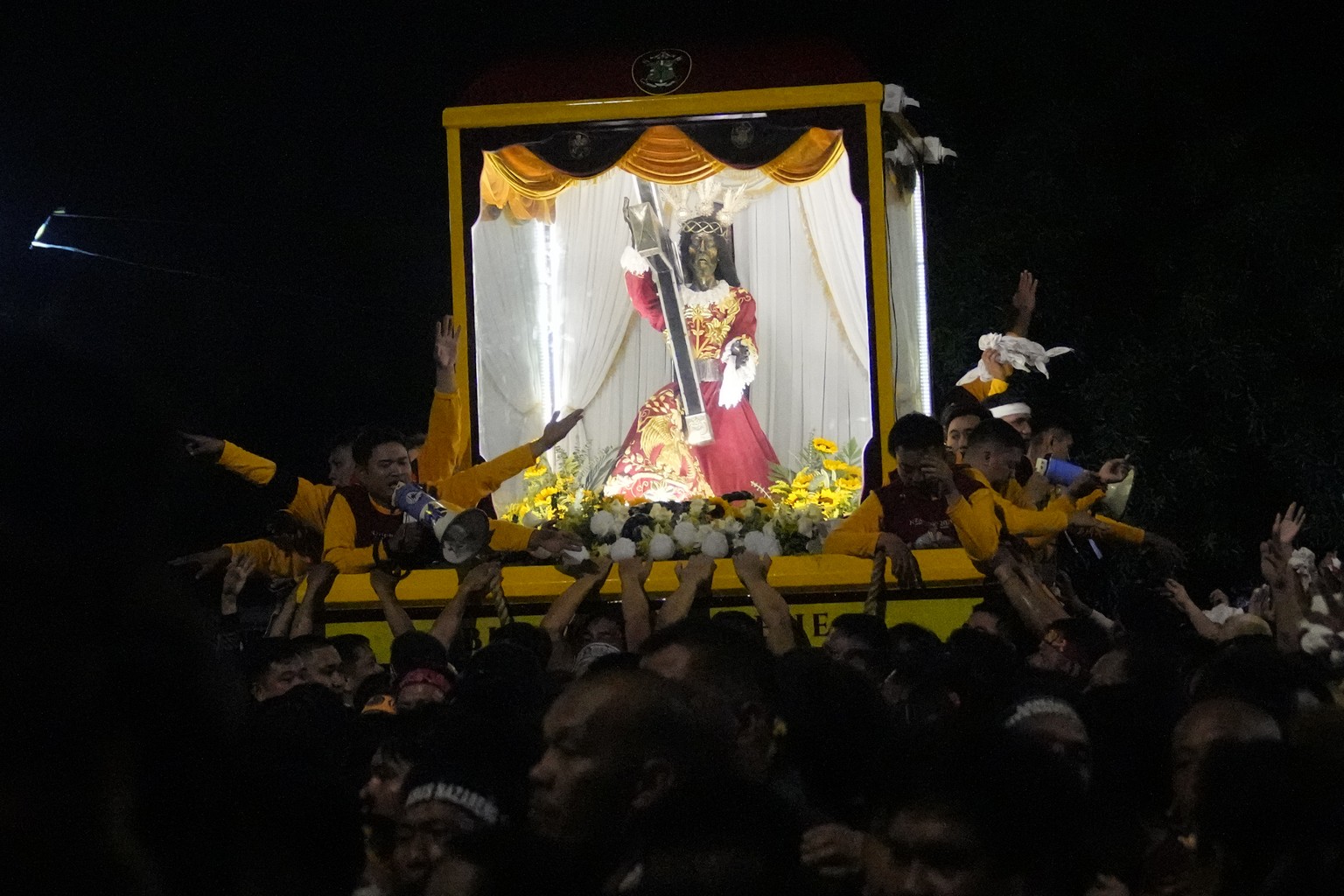 Devotees pull the statue of the Black Nazarene during the annual procession, which resumed after a three-year suspension due to the coronavirus pandemic on Tuesday, January 9, 2024, in Manila, Philippi...