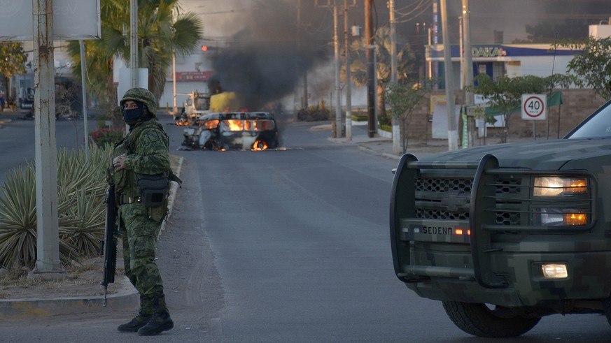 epa10390664 A truck is on fire after clashes between federal troops and armed groups in the town of Culiacan, Sinaloa state, Mexico, January 05, 2023. Authorities in Culiacan, in the ...