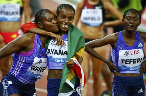 Lydia Wafula of Kenya and Almaz Ayana of Ethiopia react after the women&#039;s 3000m event at the IAAF Athletics Diamond League meeting in Zurich September 3, 2015. REUTERS/Arnd Wiegmann