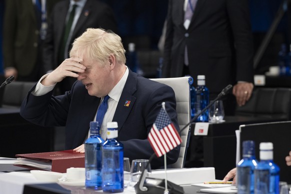 British Prime Minister Boris Johnson reacts at the start of the second plenary session of the NATO summit in Madrid, Wednesday, June 29, 2022. North Atlantic Treaty Organization heads of state will me ...