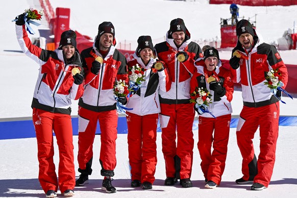 Gold medalist the team of Austria celebrate during the victory ceremony of the Alpine Skiing Mixed Team Parallel Event at the 2022 Olympic Winter Games in Yanqing, China, on Sunday, February 20, 2022. ...