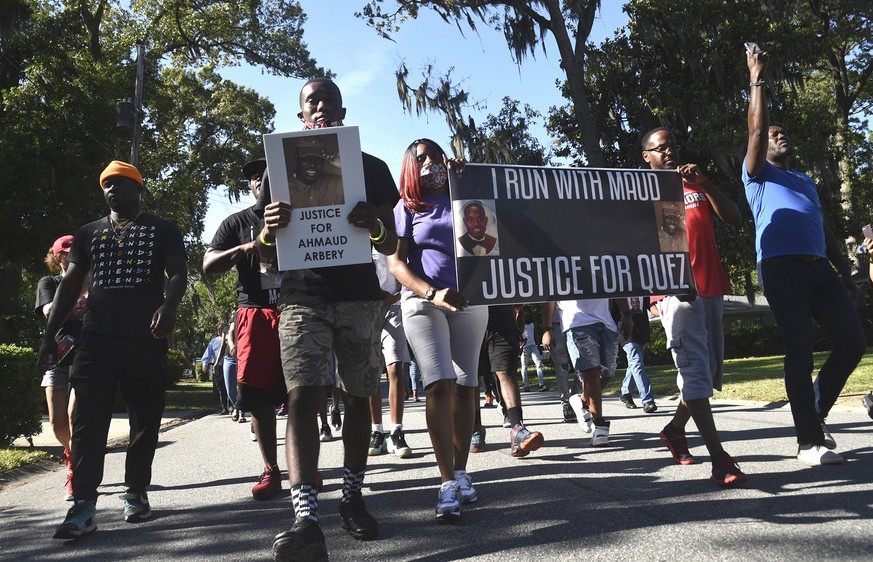 In this Tuesday, May 5, 2020, photo, a crowd marches through a neighborhood in Brunswick, Ga. They were demanding answers in the death of Ahmoud Arbery. An outcry over the Feb. 23 shooting of Arbery h ...