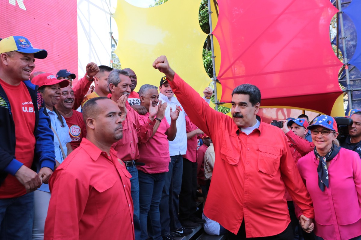 epa07541476 A handout photo made available by Miraflores' Press Office shows Venezuelan President Nicolas Maduro (C) and his wife Cilia Flores (R) as they participate in an act on the ocassion of ...