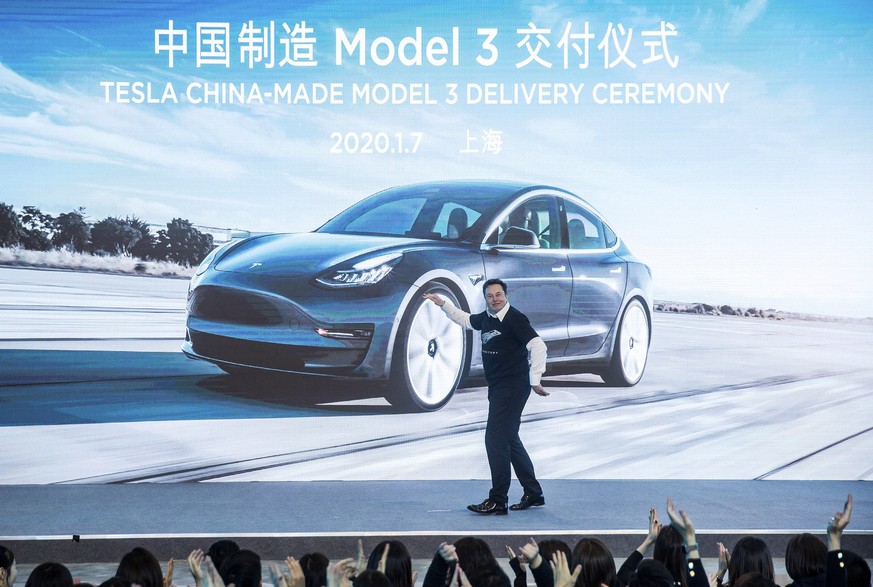 In this photo released by China&#039;s Xinhua News Agency, Tesla CEO Elon Musk reacts at a delivery ceremony for the first Tesla Model 3 cars made at Tesla&#039;s Shanghai factory in Shanghai, Tuesday ...