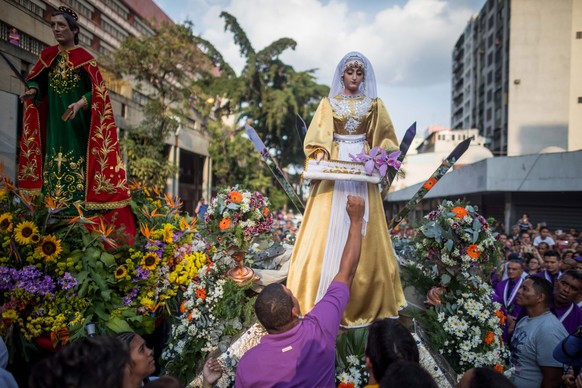 epa07513086 Parishioners and religious take part in the procession of the San Pablo Nazarene, decorated with approximately 3,000 orchids, at the Santa Teresa East Basilica, during the commemoration of ...