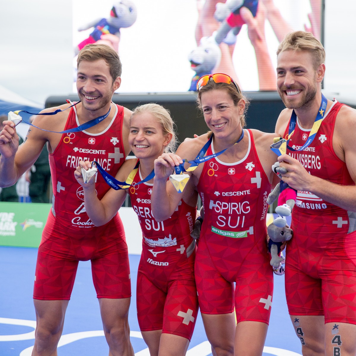 epa06944251 (L-R) Silver medalists members of Switzerland's team Sylvain Fridelance, Lisa Berger, Nicola Spirig and Andrea Salvisberg celebrate after the Mixed Relay Triathlon race of the Glasgow ...