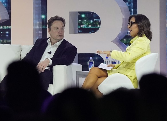 Twitter CEO Elon Musk, center, speaks with Linda Yaccarino, chairman of global advertising and partnerships for NBC, at the POSSIBLE marketing conference, Tuesday, April 18, 2023, in Miami Beach, Fla. ...