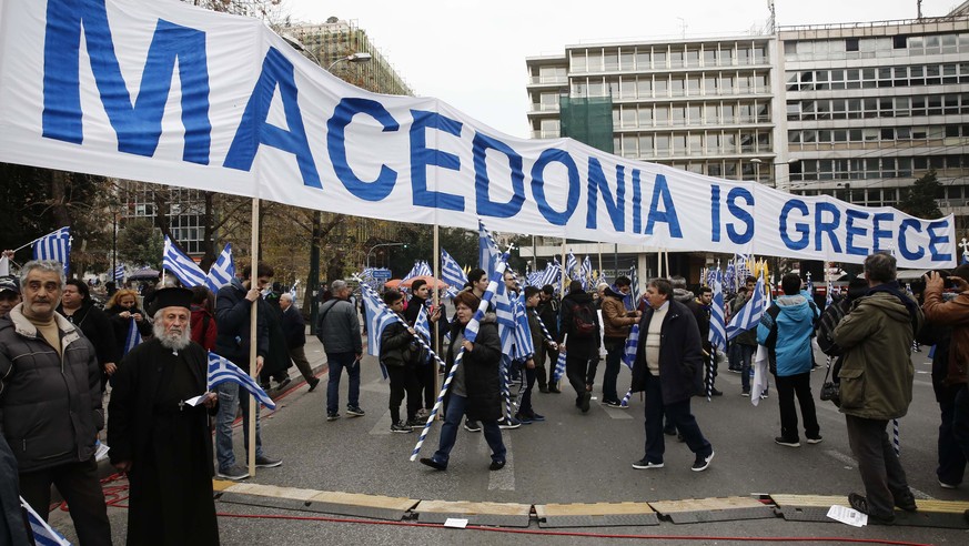 epa06495768 Protersters hold a banner thar reads &#039;Macedonia is Greece&#039; during a massive rally over the name of the Former Yugoslav Republic of Macedonia (FYROM) against to its use of the nam ...