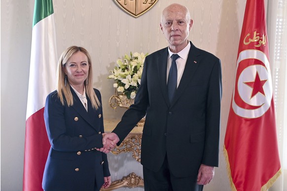 Tunisian President Kais Saied, right, shakes hands with Italian Prime Minister Giorgia Meloni at the Carthage presidential palace in Tunis, Tunisia, Tuesday, June 6, 2023. (Slim Abid/ Tunisian Preside ...