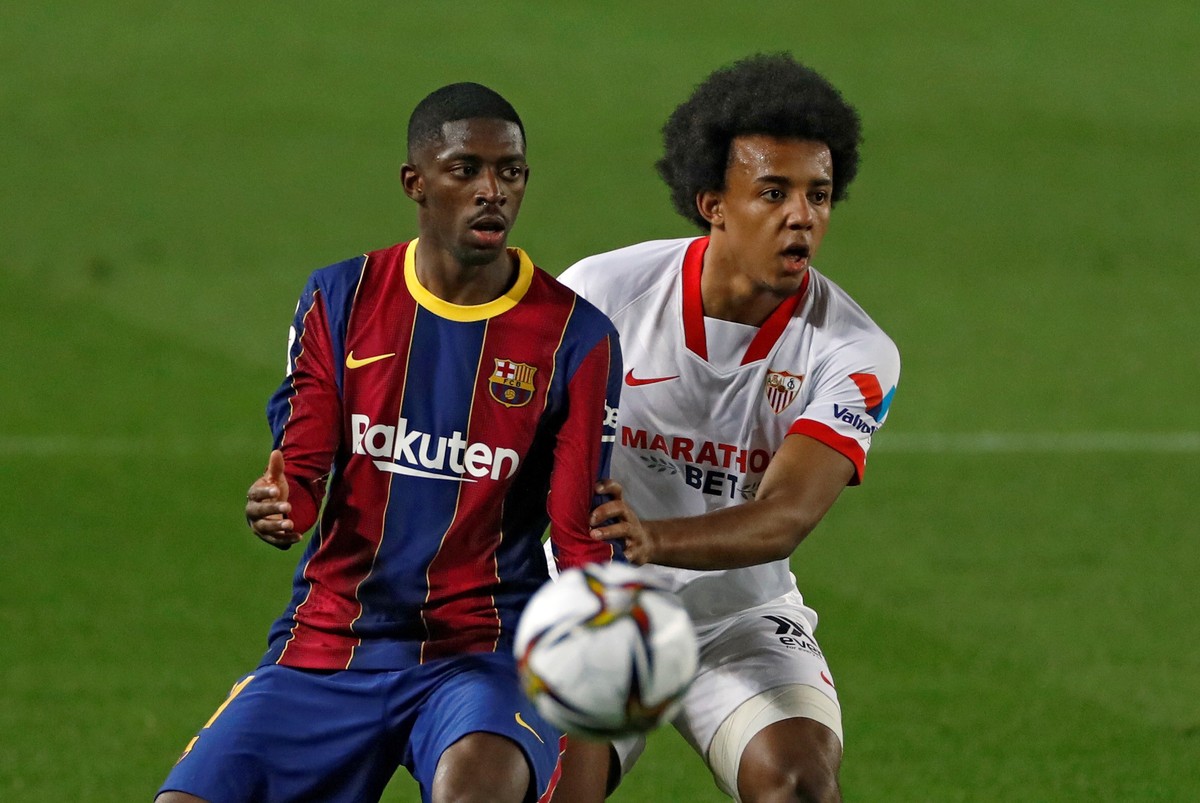 epa09049822 FC Barcelona's striker Ousmane Dembele (L) vies for the ball with Sevilla's defender Jules Kounde (R) during the second leg soccer match of the Spanish King's Cup semi final ...