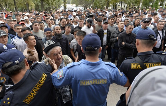 Kyrgyz volunteers gather outside the government building demanding they be sent to the conflict zone at the Kyrgyz-Tajik border, in Bishkek, Kyrgyzstan, Friday, Sept. 16, 2022. Kyrgyzstan and Tajikist ...