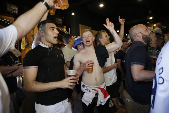 Tottenham supporters shoot out in a pub in downtown Madrid ahead to the Champions League final soccer match between Tottenham Hotspur and Liverpool at the Wanda Metropolitano Stadium in Madrid, Saturday, June 1, 2019. (AP Photo/Andrea Comas)