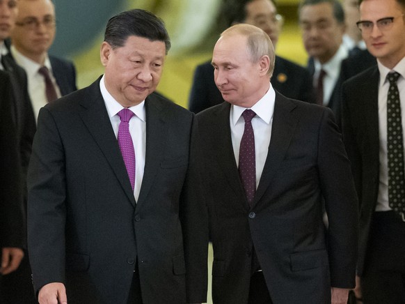 FILE - Chinese President Xi Jinping, center left, and Russian President Vladimir Putin, center right, enter a hall for talks in the Kremlin in Moscow, Russia, June 5, 2019. Xi and his Russian counterp ...
