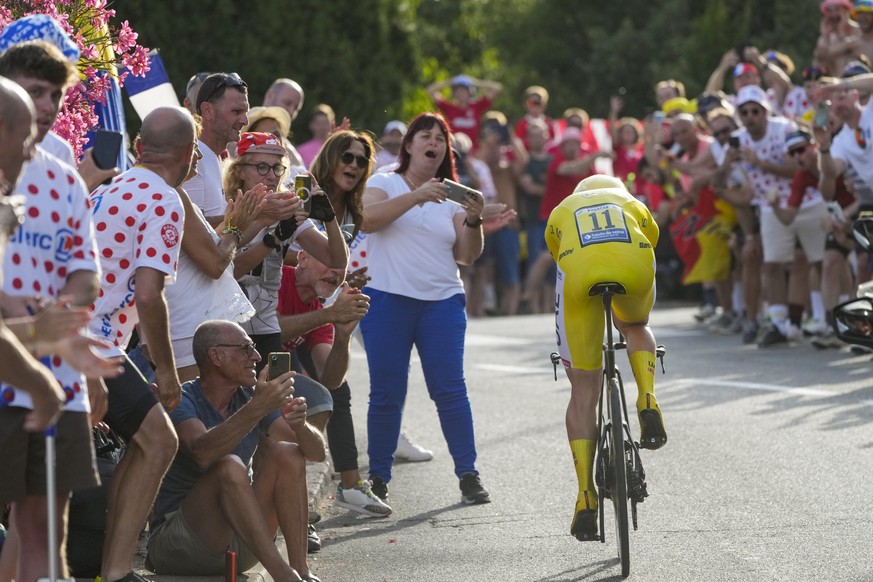 Slovenia&#039;s Tadej Pogacar, wearing the overall leader&#039;s yellow jersey, climbs during the twenty-first stage of the Tour de France cycling race, an individual time trial over 33.7 kilometers ( ...