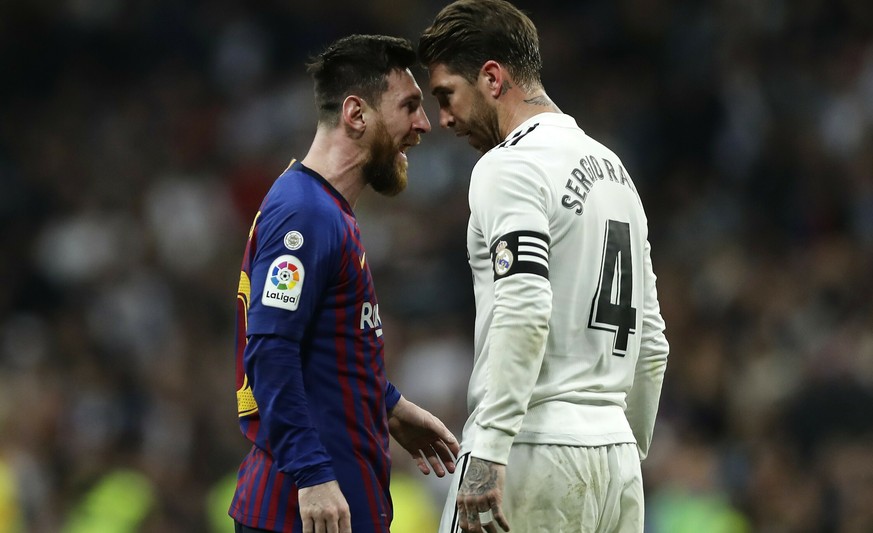 FILE - In this March 2, 2019 file photo, Barcelona forward Lionel Messi, left, goes head to head with Real defender Sergio Ramos as they argue during the Spanish La Liga soccer match between Real Madr ...