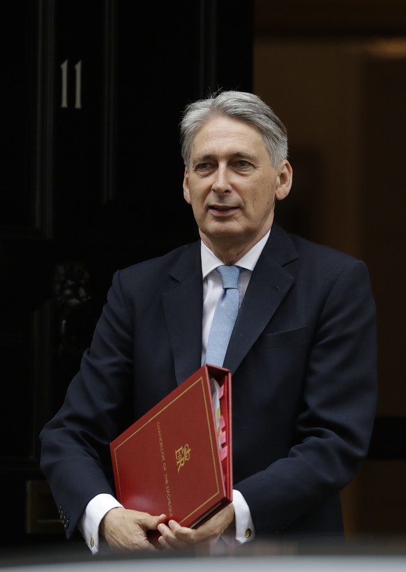 Britain&#039;s Chancellor of the Exchequer Philip Hammond leaves 11 Downing Street in London, to attend Prime Minister&#039;s Questions at the Houses of Parliament, Wednesday, June 28, 2017. (AP Photo ...