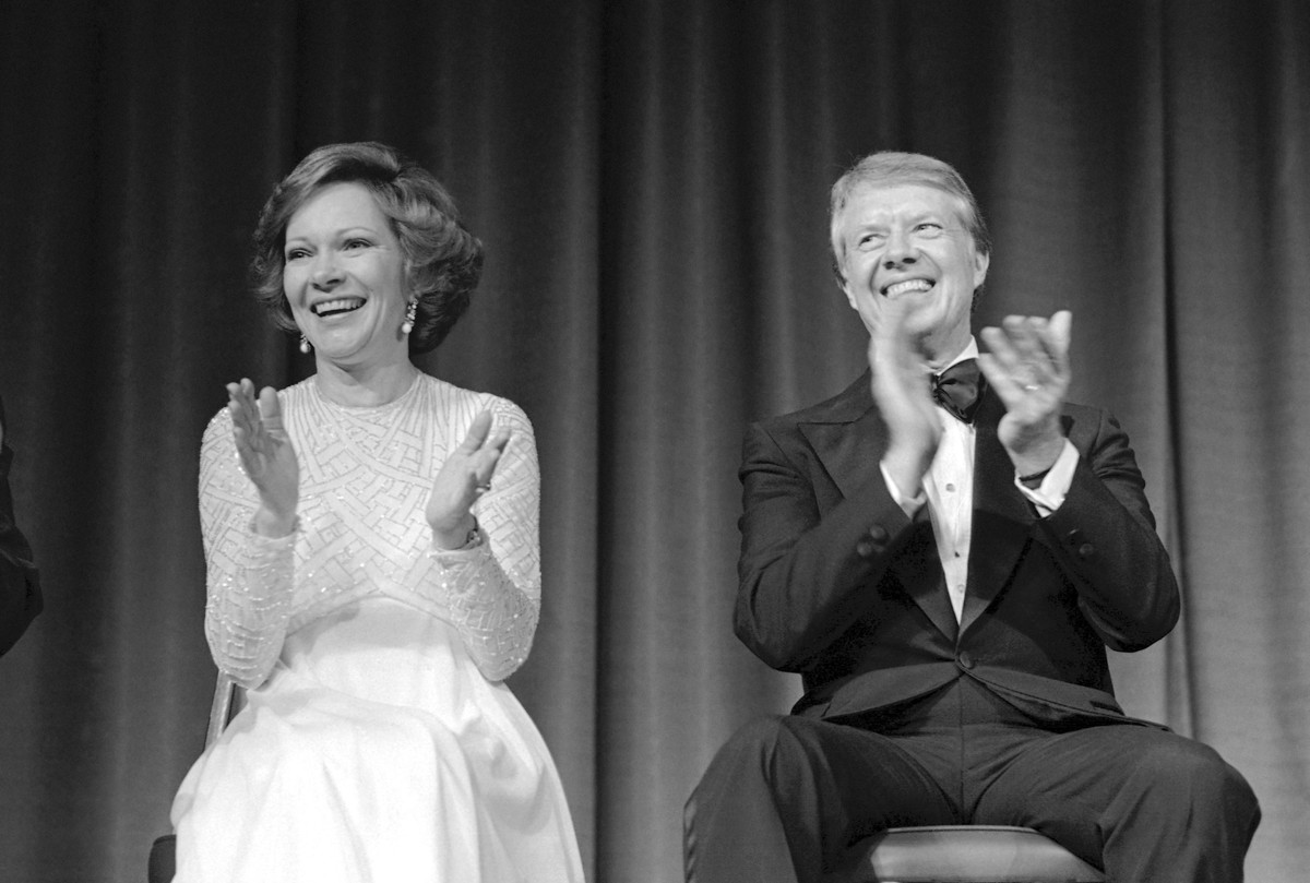 FILE - President Jimmy Carter, right, and first lady Rosalynn Carter laugh while applauding speeches after a dinner, Jan. 20, 1978, in Atlanta, where they were honored guests. Rosalynn Carter, the clo ...