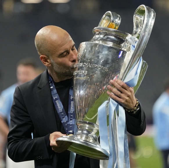 Manchester City&#039;s head coach Pep Guardiola kisses the trophy after winning the Champions League final soccer match between Manchester City and Inter Milan at the Ataturk Olympic Stadium in Istanb ...