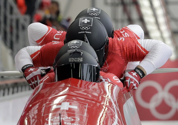 Driver Rico Peter, Michael Kuonen, Simon Friedli and Thomas Amrhein of Switzerland start their heat on the first day of four-man bobsled competition at the 2018 Winter Olympics in Pyeongchang, South K ...