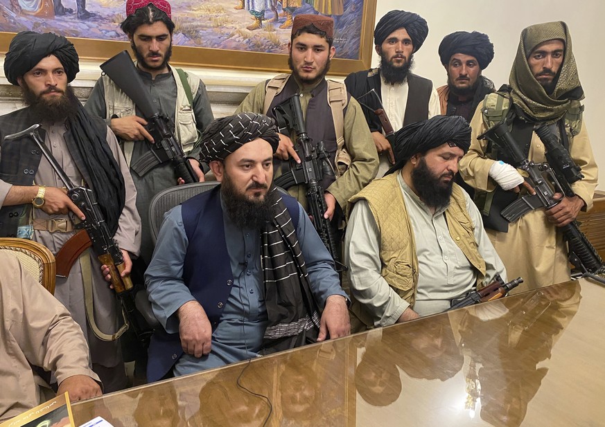 Taliban fighters take control of Afghan presidential palace after the Afghan President Ashraf Ghani fled the country, in Kabul, Afghanistan, Sunday, Aug. 15, 2021. (AP Photo/Zabi Karimi)